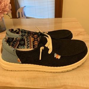 Hey Dude slip on shoes size 7. Black on the front and denim around the heel